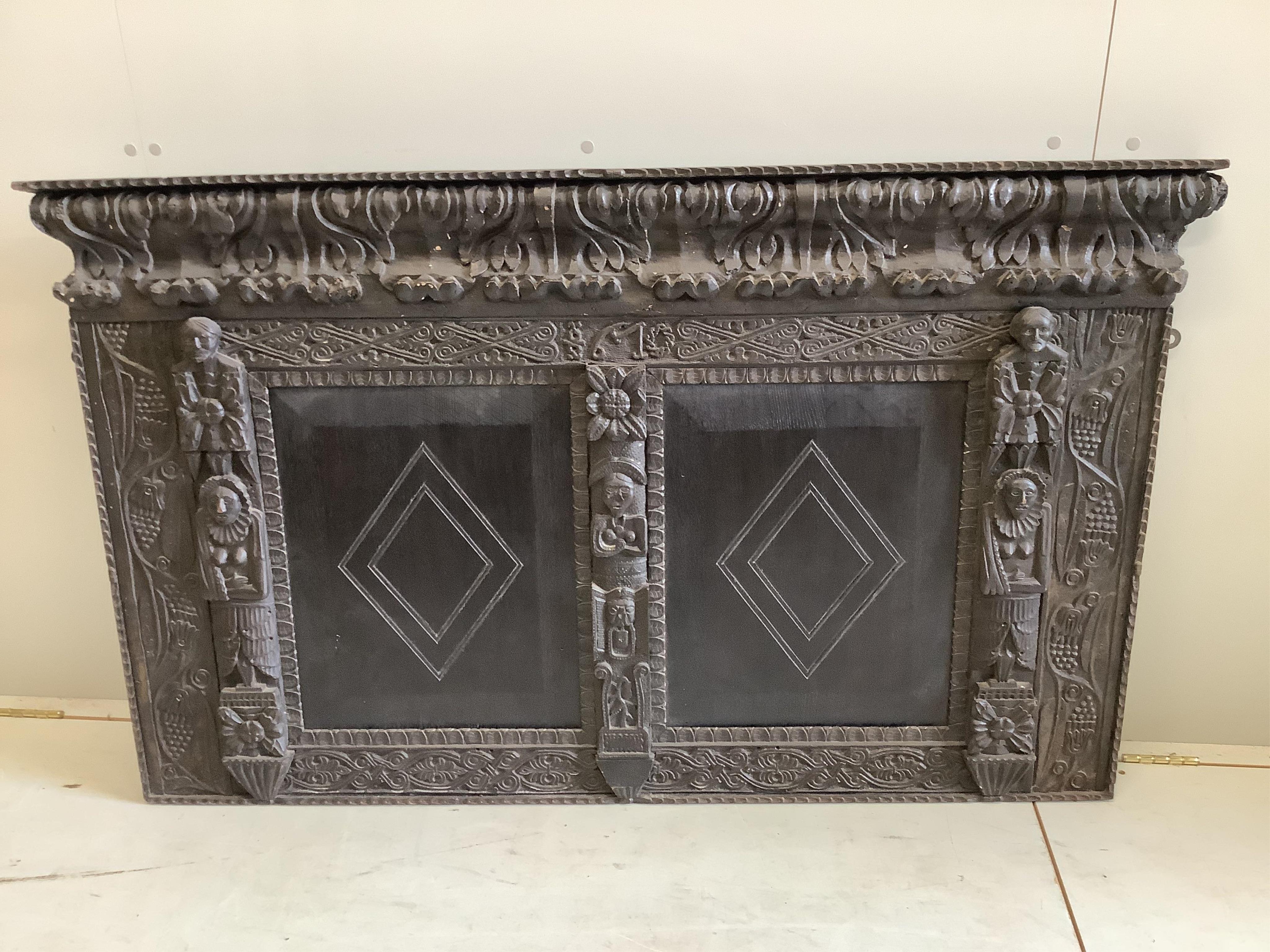 A carved ebonised oak panel, width 145cm, height 88cm. Condition - fair